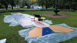 Mary Lacy painting components of her trout mural