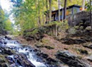 How a Creek-Side Cabin in Waterbury Was Transformed Into an Industrial-Chic Bachelor Pad