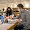 Samjana Rai discussing her college essay with Adam Hurwitz of the University of Vermont's Upward Bound program in the Burlington High School library