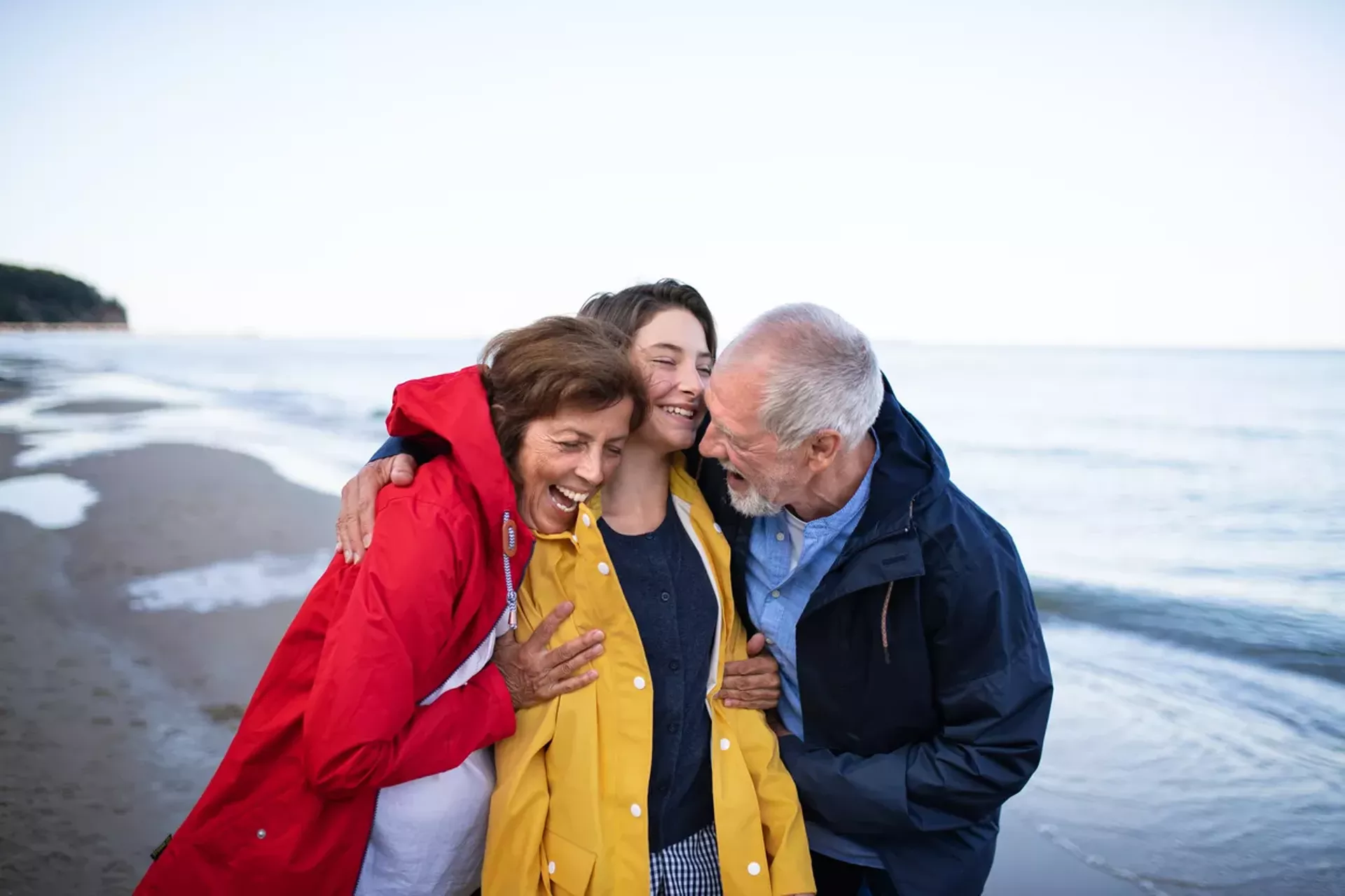 older_couple_hugs_grandaughter.webp